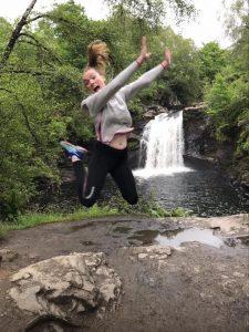 Jumping for joy after a trip away in a VW Campervan