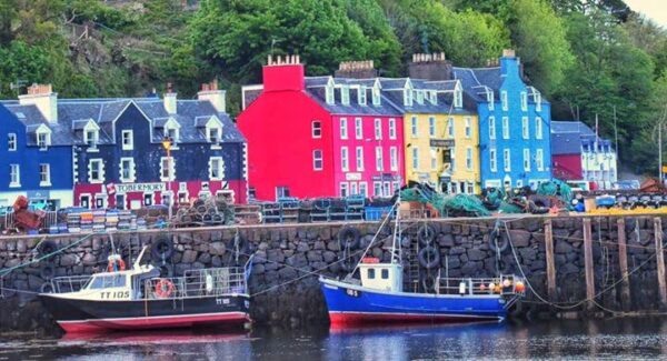 The Mishnish on the shores of Tobermory surrounded by the colourful houses while on tour with Four Seasons Campers