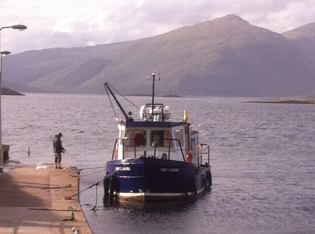 boat landing at port appin in loch linnhe Scotland with mountain in back ground