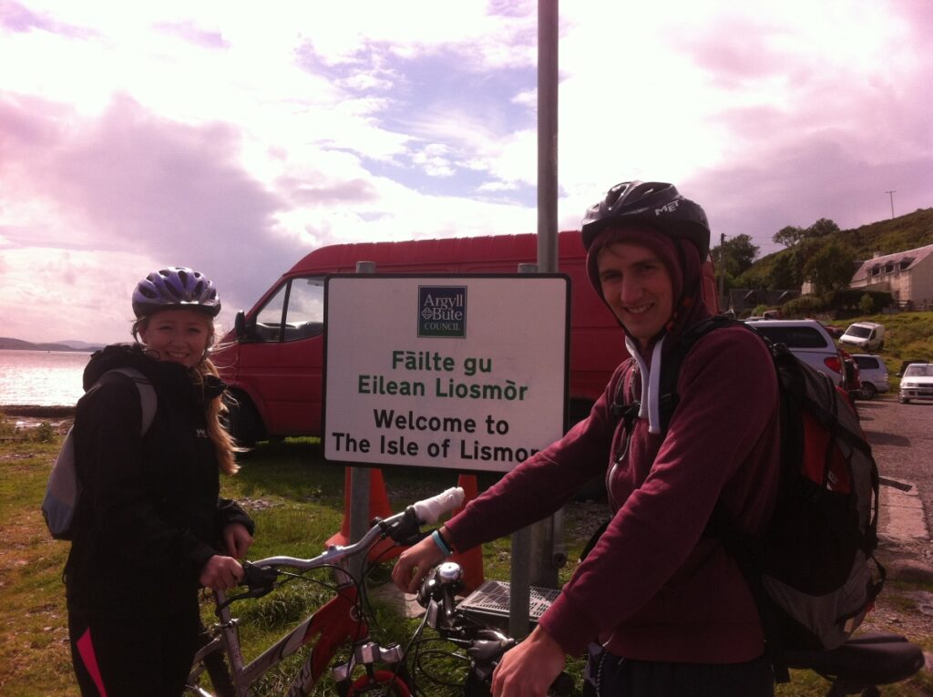 teenagers on bikes at lismore island sign on loch linnhe Scotland