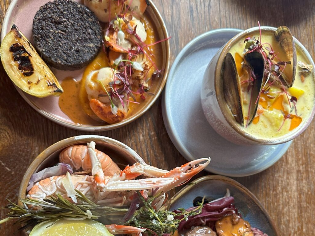 cottish food assortment of languoustine, black pudding, scallops, cullen skink on road trip with Four Seasons Campers.jpg