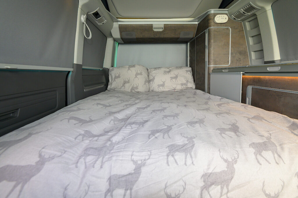 campervan bed with stag duvet and pillows when hire with Four Seasons Campers campervan hire Scotland