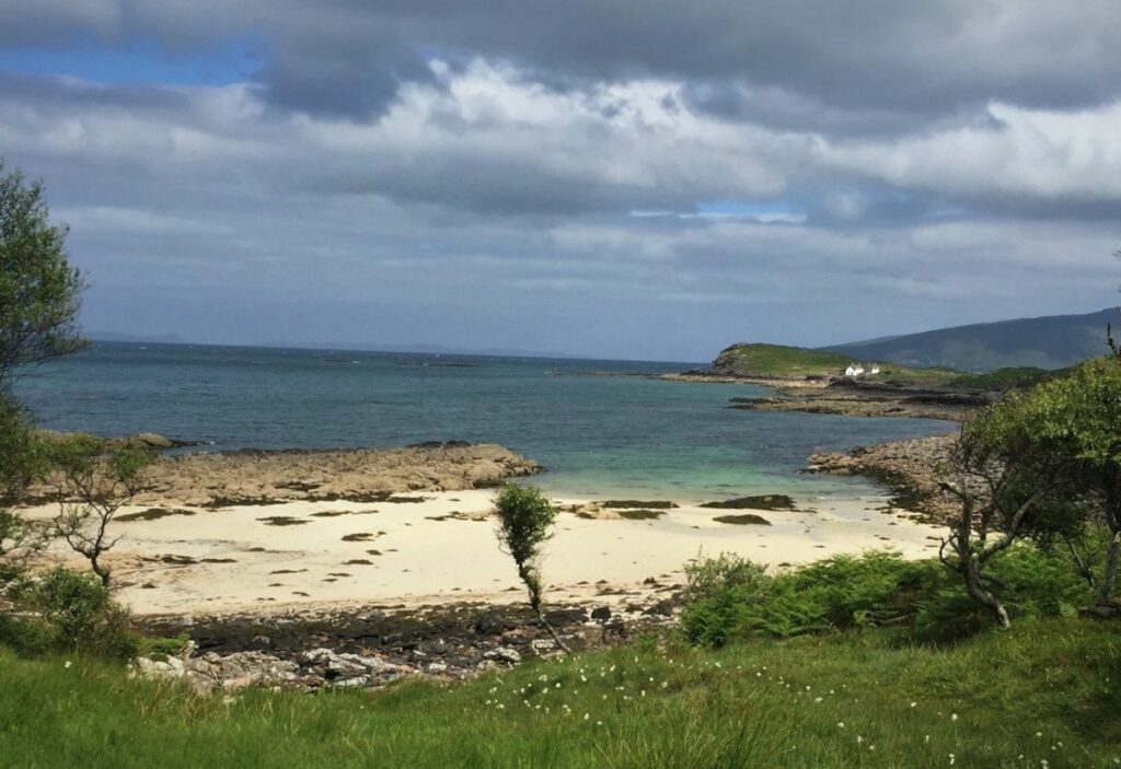 Coral beach at Applecross with trees, beach and blue sea