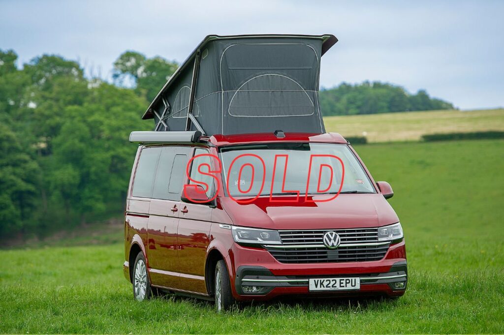 VW Campervan for Sale with pop up roof in red in field at Four Seasons Campers campervan hire Scotland