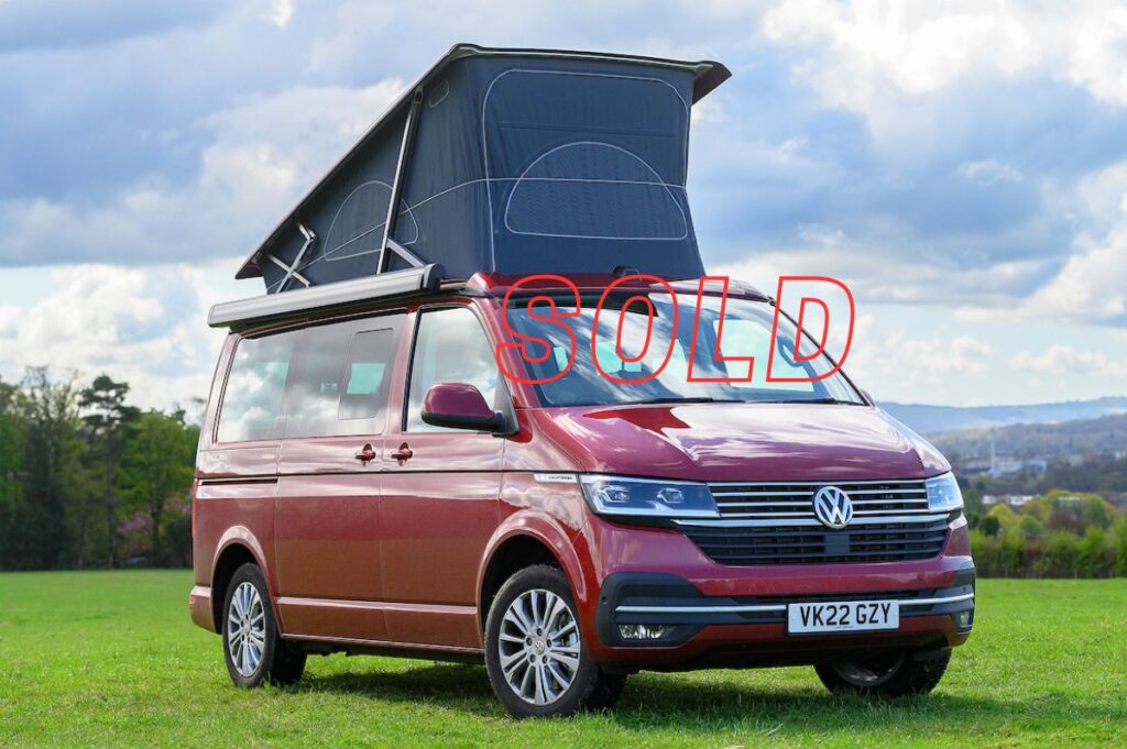 VW Campervan for Sale with pop up roof in red in field at Four Seasons Campers campervan hire Scotland