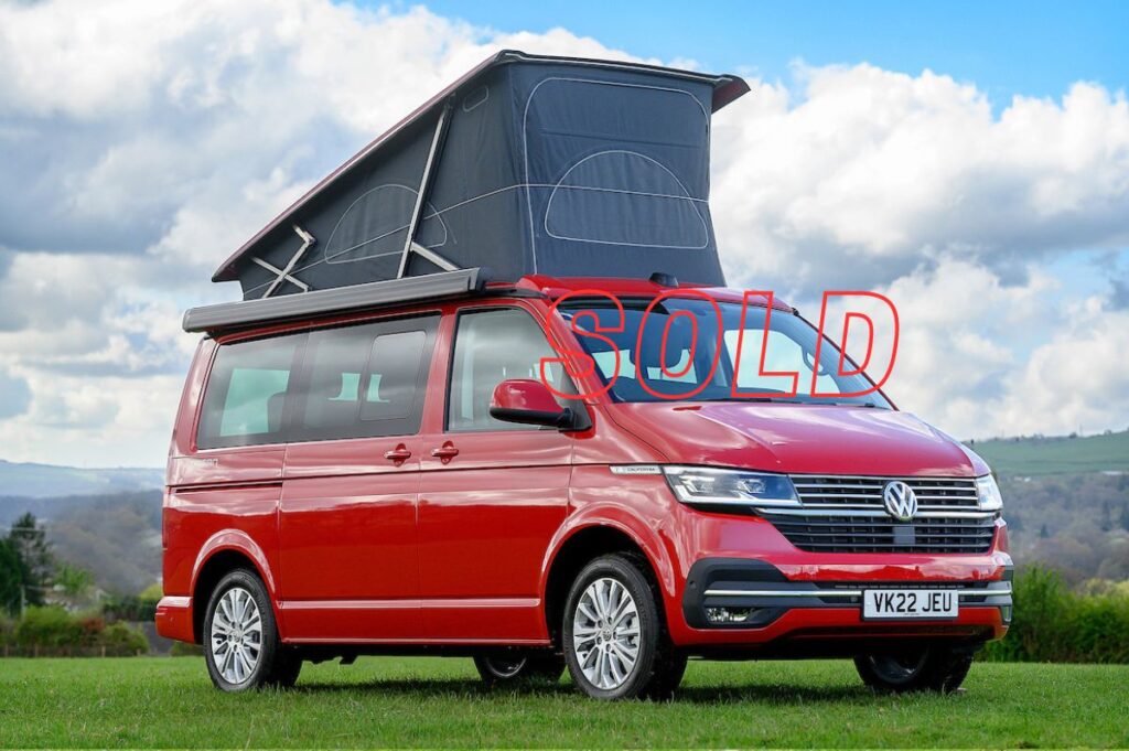 VW Campervan for Sale with pop up roof in cherry red in field at Four Seasons Campers campervan hire Scotland