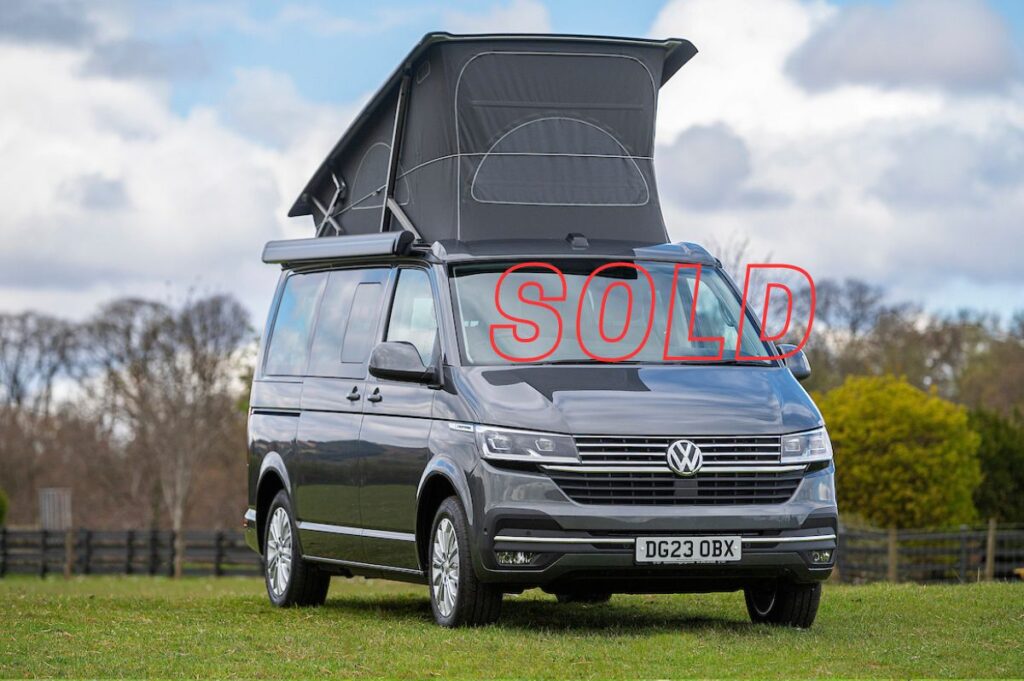 VW Campervan for Sale with pop up roof in indium grey in field at Four Seasons Campers campervan hire Scotland