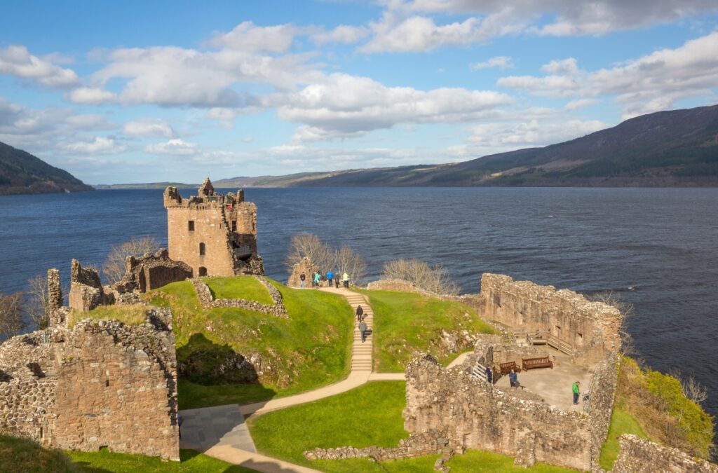 Urquhart Castle with loch ness behind it in Scotland