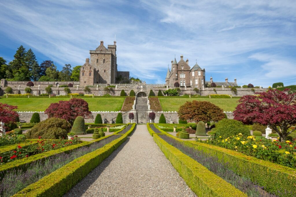 Drummond Castle Gardens in Scotland with path to castle and gardens on each side and castle at top