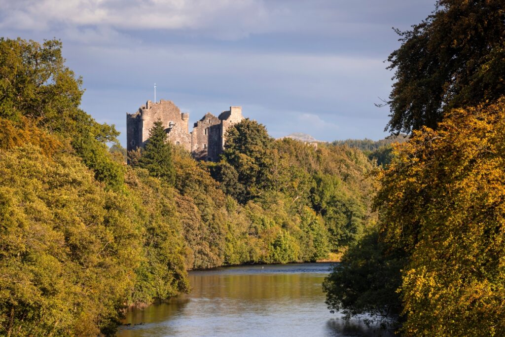 Doune Castle used as Caslte Leoch in OUtlander sits in trees with river Teith below