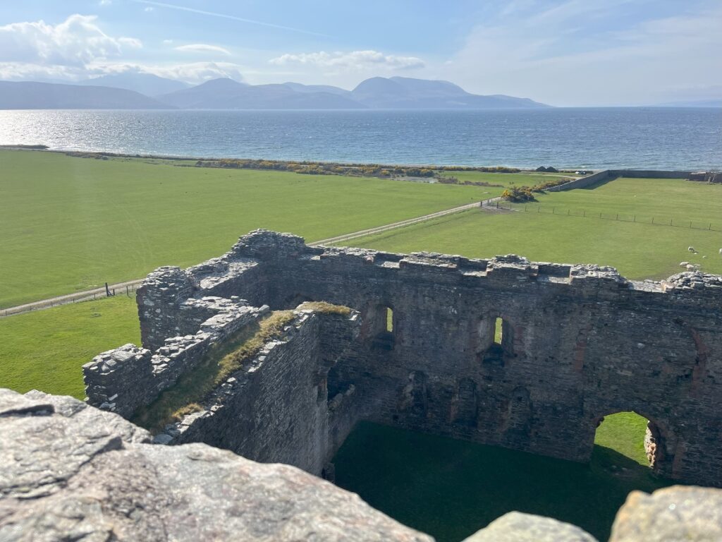 Skipness Castle Mull of Kintyre with view across fields and sea to island of Arran Scotland