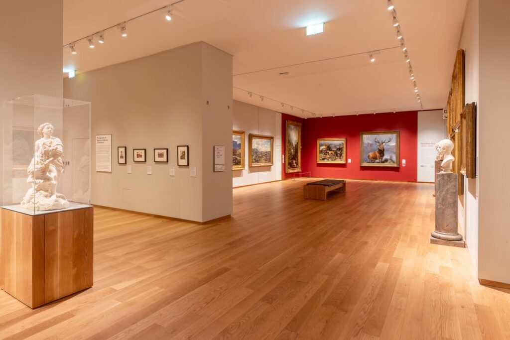 gallery with wooden floor and red wall with paintings in national galleries of Scotland in Edinburgh