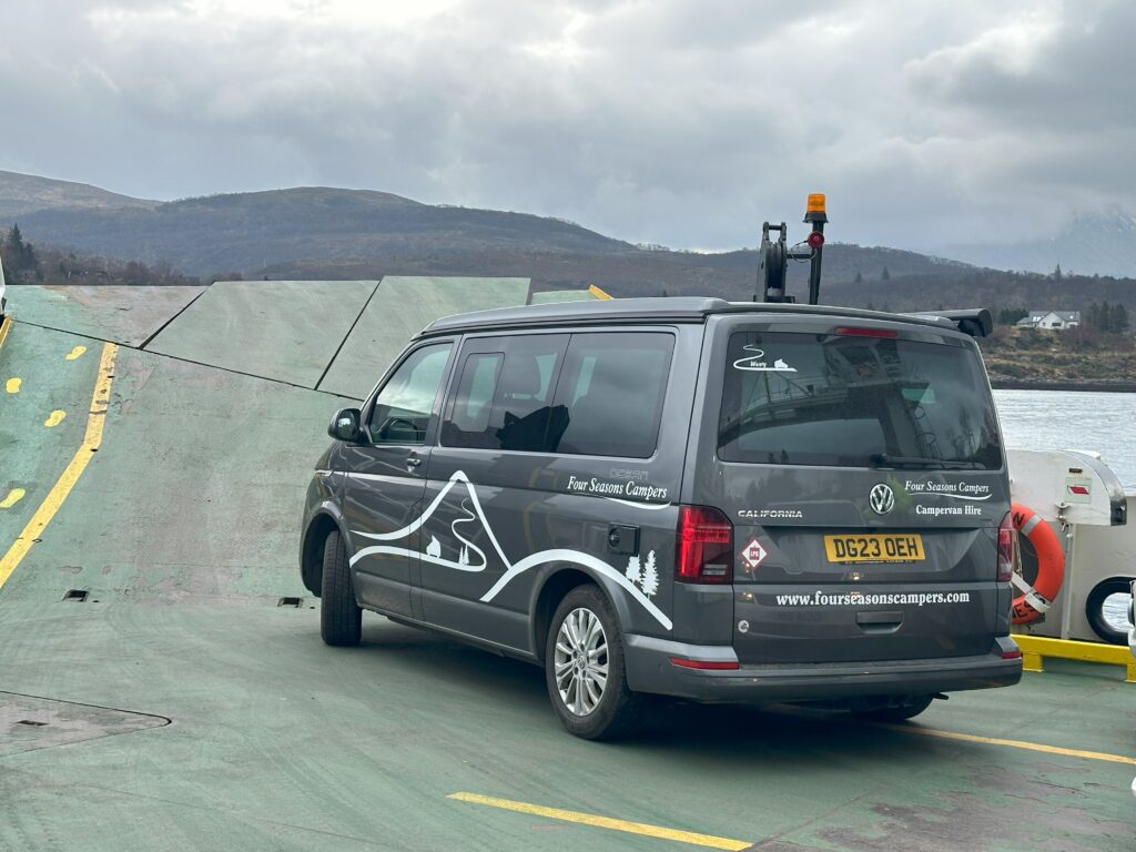 campervan on ferry with Four Seasons Campers graphics on in Scotland