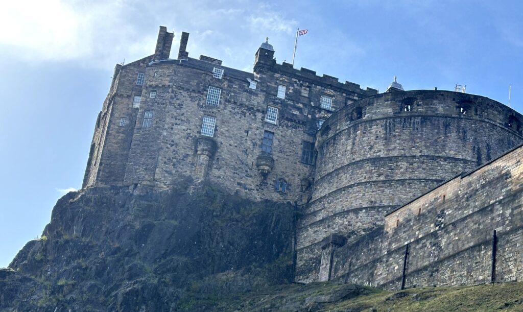 Edinburgh Castle in Edinburgh with rock and turret and blue sky in August at Tatoo