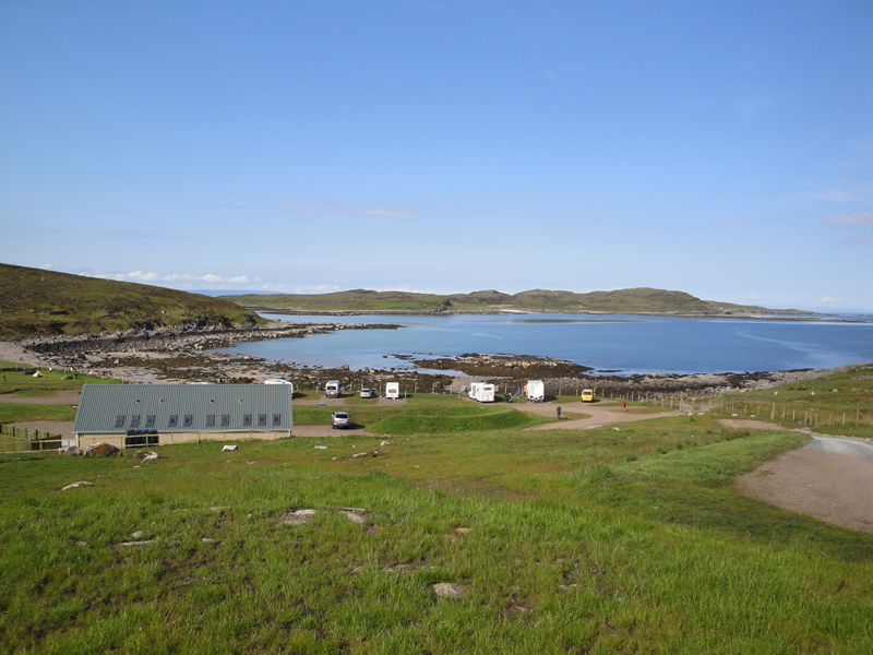 Port a Bhaigh campsite Scotland with toilet block and sea and beach