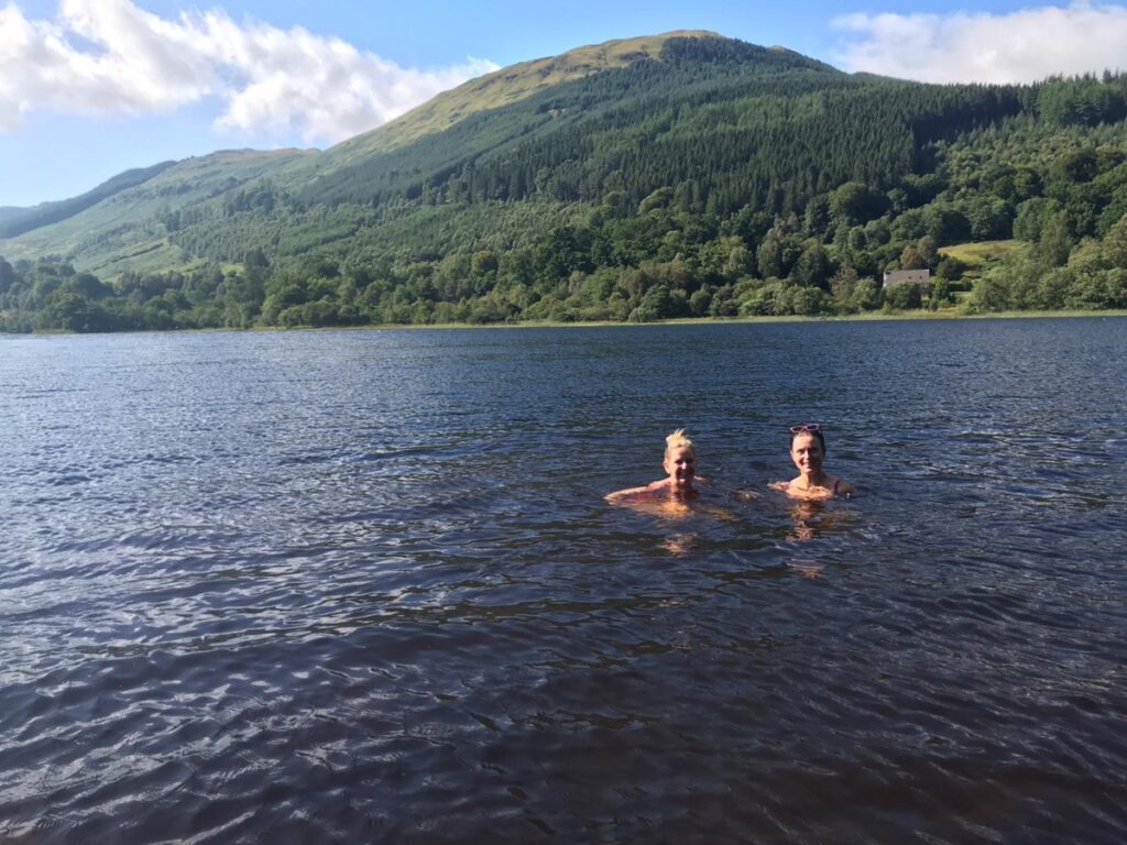 wild swimming loch voil balquhidder 2 women swimming in loch with hill in background