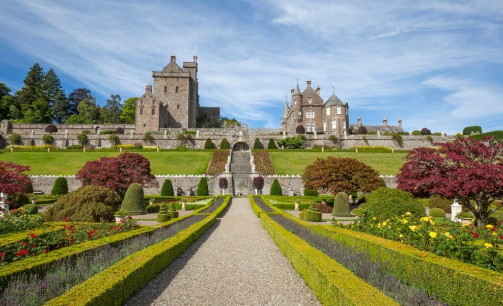 Drummond Castle Gardens in Scotland with path to castle and gardens on each side and castle at top