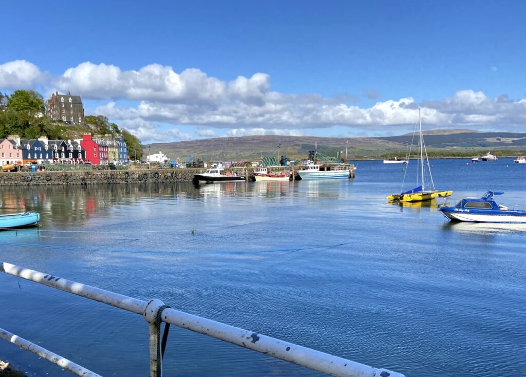 The Mishnish on the shores of Tobermory surrounded by the colourful houses while on tour with Four Seasons Campers