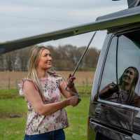 Campervan handover Becky shows awning for Four Seasons Campers road trip Scotland
